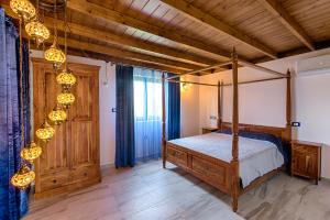 a bedroom with a bed and a wooden ceiling at Lianas Garden House in Rhodes Town