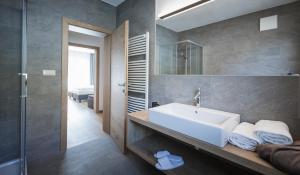 a bathroom with a white sink and a shower at Residence Margareth in Campo Tures