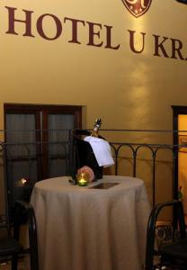 a table with a bottle of alcohol on top of it at Hotel U Krále in Jičín