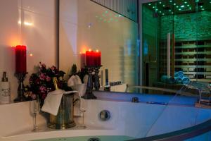 a bathroom sink with two candles and a mirror at Luxuslodge Wernigerode in Wernigerode +103 photos
