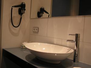 a bathroom with a large white bowl sink on a counter at Hotel zur Promenade in Donauwörth