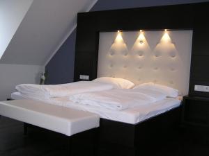 
a hotel room with a white bed and white walls at Hotel zur Promenade in Donauwörth
