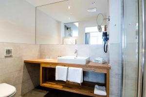 a bathroom with a sink and a mirror at Chalet M in Ischgl