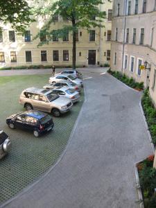 a group of cars parked in a parking lot at Central Park Rooms in Riga