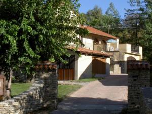a house with a stone wall and a tree at Bricco di Sant' Eufemia in Bossolasco