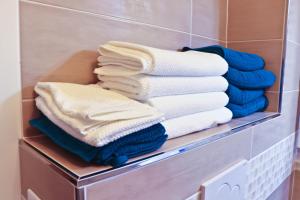 a stack of towels on a shelf in a bathroom at The Princess Monac'home Parking in Monte Carlo