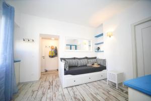 a bedroom with a bed in a white room at Faro della Madonetta in Bonifacio
