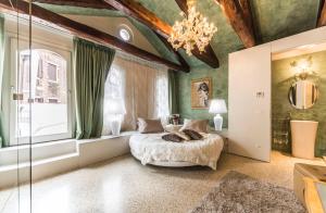 a bedroom with a bed and a chandelier at San Marco Terrace in Venice