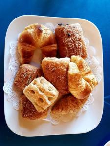 a plate of pastries and waffles on a plate at Il Baglio Della Luna Relais in Balestrate