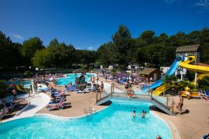 a group of people in a pool at a water park at Camping Lou Pignada ***** in Messanges
