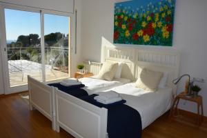 a bedroom with two beds and a large window at Villa Sitges Loto Amazing View Confortable AC 20 minutes walk Sitges beaches in Sitges