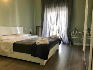 Postel nebo postele na pokoji v ubytování L'Arena Residence