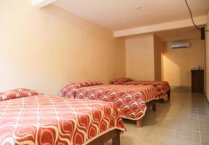 Voodi või voodid majutusasutuse Hotel Santa Rita toas