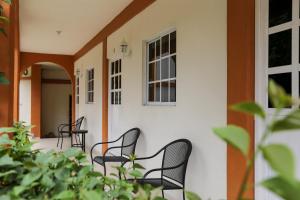 two chairs sitting on the porch of a house at Hotel Santa Rita in Huichihuayán