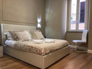 a bedroom with a bed with two towels on it at Pantheon Luxury Suite in Rome