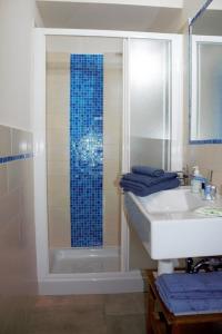 a bathroom with a shower and a sink and a mirror at Villa Tre Cariole in Colico +36 photos