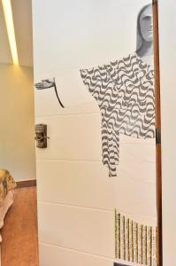 a dresser with a shirt hanging on a wall at Lapa Chêca Guest House in Rio de Janeiro