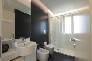 a white bathroom with a sink and a shower at apARTments Sperlonga in Sperlonga +37 photos