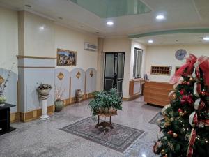 ein Weihnachtsbaum mitten im Zimmer in der Unterkunft Grand Hotel Aspromonte in Delianuova