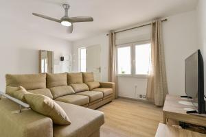 salon z kanapą i telewizorem w obiekcie Casa Marina La Zenia w mieście Orihuela