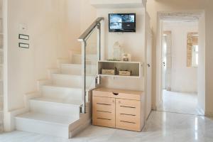 a staircase in a home with white walls and white floors at Ontas Villa Loutraki Platanias in Gerani Chanion