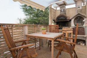 a patio with a table and chairs and an outdoor oven at Ontas Villa Loutraki Platanias in Gerani Chanion