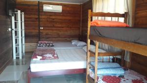 two bunk beds in a room with wooden walls at Da Silva Chalé in São Lídio +19 photos