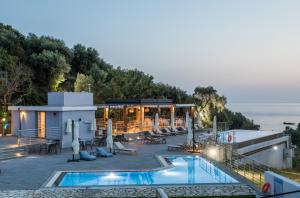 a resort with a swimming pool and a building at Aqua Oliva Resort Syvota in Sivota