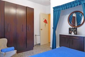 a bedroom with a bed and a mirror and a cabinet at El mirador del mar in Ferrol