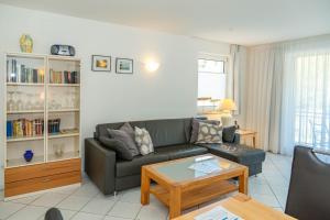 a living room with a couch and a table at Apartment Astra mit 2 Balkone in Zempin