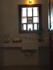 a bathroom with a sink and a mirror at Casa Violeta in Tulum