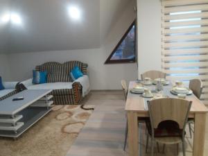 a living room with a table and a couch at Edo in Visoko