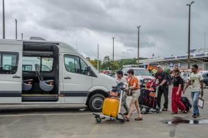 a group of people standing next to a van with luggage at Monte Amazonico Lodge in Tambopata