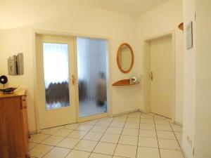 an empty hallway with a door and a window at Apartment Lotte mit Terrasse in Zempin