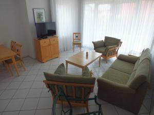 a living room with a couch and chairs and a table at Apartment Lotte mit Terrasse in Zempin +28 photos