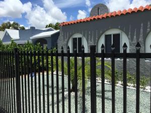 a black fence in front of a house at Modern 3/1 house close to Beaches and Midtown in Miami