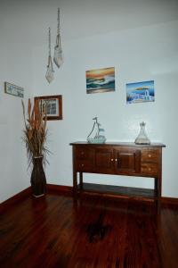 a room with a wooden desk and a vase of flowers at Kalani Hawaii Private Lodging in Pupukea