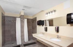 a bathroom with two sinks and a shower at Chicago Parthenon Hostel in Chicago