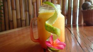 a mason jar filled with a drink with a flower at Rumah Made in Amed