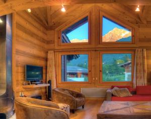 a living room with a large room with windows at CHALET CHAM'ROCK in Les Houches