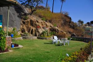 two chairs and a table in a yard at Hotel Oasis in Mount Ābu