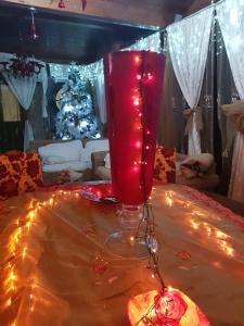 un jarrón rojo sentado sobre una mesa con luces en B&B Marilena affittacamere, en Rocca Imperiale