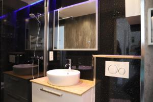 a bathroom with a sink and a mirror at Heeren van Noortwyck in Noordwijk aan Zee +32 photos