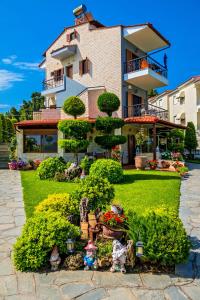 a house with a garden in front of it at Akrathos Houses in Polychrono