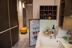a kitchen with an open refrigerator and a sink at Apartment Rotonda in Sofia