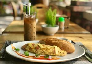 a plate of food with a sandwich on a table at Vung Bau Resort in Phú Quốc +37 photos