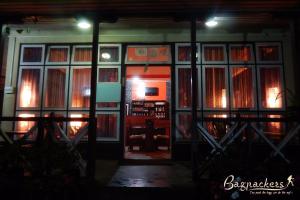 a room with a wall of windows and a door at Lampokhari Village Resort - Aritar in Aritar