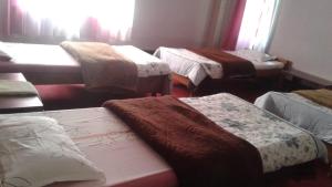 a group of beds in a room at Lampokhari Village Resort - Aritar in Aritar