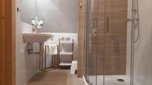a bathroom with a sink and a shower at Domek Góralski na Gubałówce in Zakopane +29 photos