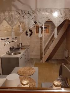 a kitchen with a sink and a staircase at Domki z jacuzzi Pasja I in Mizerna